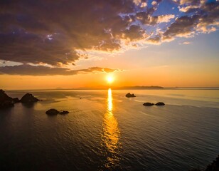 Aerial view of sunset over tranquil ocean with islands and clouds