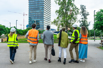 Engineering and architecture team discussing at urban construction site