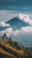 Clouds Rolling Over Volcano Mountain in Indonesia with Dramatic Tropical Landscape and Natural Atmosphere