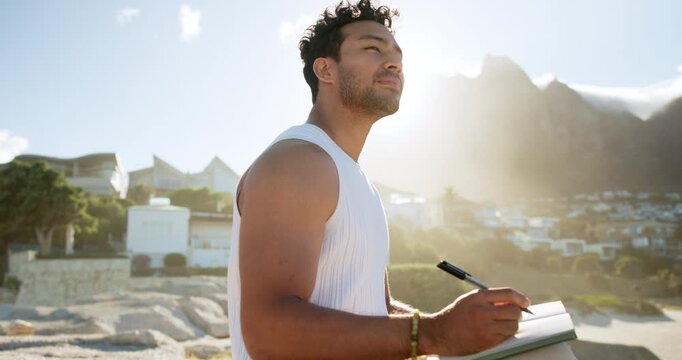 Beach, thinking and man writing in journal for emotions, mental clarity or self care on holiday. Pen, ideas and person with diary for reflection by ocean for calm, peace or mindfulness on vacation.