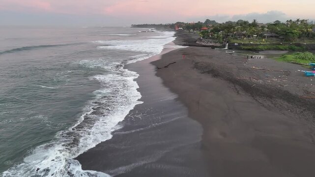 Bali beach called Prerenan north of Canggu I have recorded this drone footage at first sunlight at 5am, waiting for the sun to come up over the horizon, hitting all the notes from pink to orange, whil