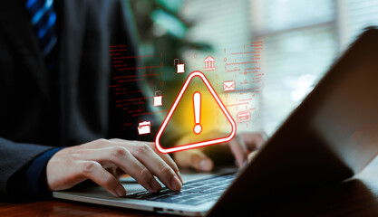 Cyber security alert concept with warning symbol over businessman using laptop. Digital data protection, online banking risk, hacking threat, malware, phishing attack and information security breach 