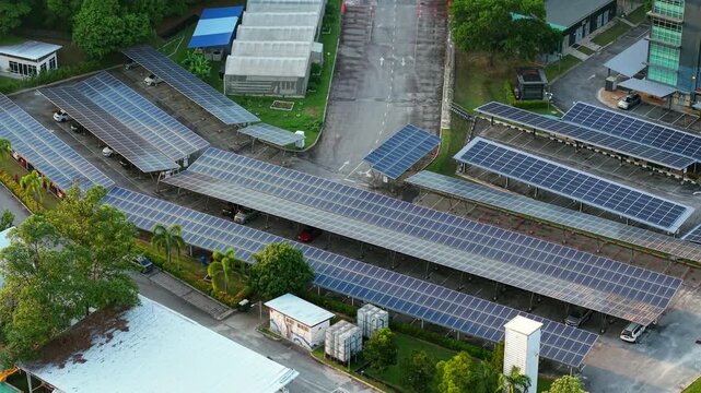 Clean aerial close-up of solar panel canopies installed over a parking facility in Malaysia. Suitable for sustainability presentations, business reports, and renewable energy visual design.