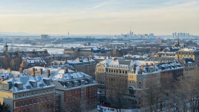 Snow rooftop sunrise over snowy historic building cityscape with distant skyline panorama