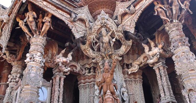 Intricate exterior architecture of wooden structure of Hindu and Buddhist gods Sanctuary of Truth temple in Pattaya city, Thailand