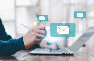 Business person using laptop with email notification icons, digital communication and online messaging concept modern workplace, email marketing, customer support and technology connection background.