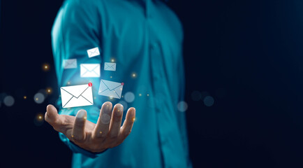 Business communication concept with floating email icons above open hand, digital messaging and inbox notification, modern technology, email marketing, customer contact and online network connection.