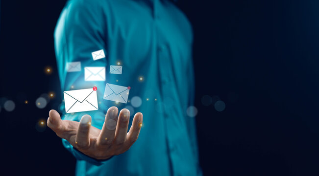 Business communication concept with floating email icons above open hand, digital messaging and inbox notification, modern technology, email marketing, customer contact and online network connection. - Powered by Adobe