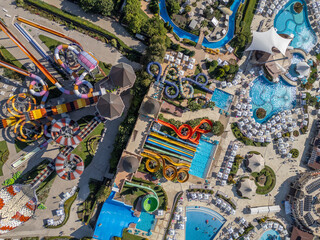 Top-down aerial view of a colorful water park in Nessebar, Bulgaria, with pools and slides. Vibrant summer resort scene showing leisure, recreation and tourism from a drone perspective