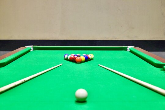Pool or billiards table with colored and numbered balls 