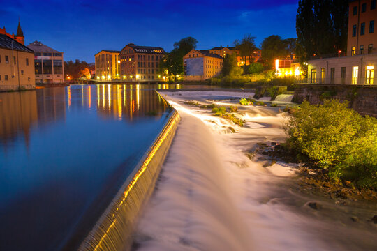 Historical textile industrial landscape and the dam on Motala river stream in the old city center taken from Campusbron towards to Dragsbron. Norrkoeping, East Gothland, Sweden