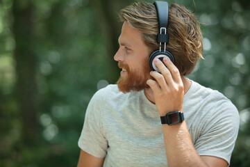 young man outdoors wearing headphones