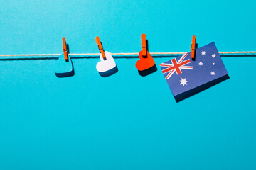 Heart shapes and australia flag hanging on clothesline with copy space over blue background