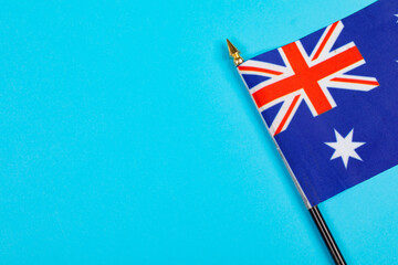 Star and union jack on australia flag stick by copy space over blue background