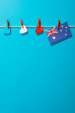 Australia flag and heart shapes hanging on clothesline with copy space against blue background