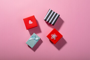 Overhead view of colorful gift boxes on pink background, copy space