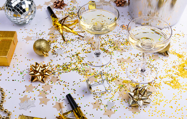 High angle view of champagne glasses with gold colored decoration on table, copy space