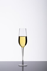 Champagne flute on table isolated over white background, copy space