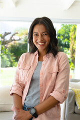 Portrait of cheerful young beautiful african american woman standing at home
