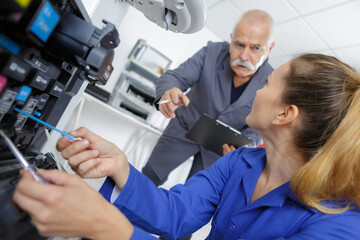 young woman fixing a printer