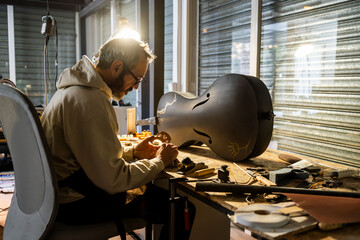 Crafting a Carbon Fiber Cello in a Luthier Studio at Dusk
