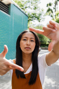Urban creative framing with hands in perspective outdoors