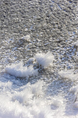 A detailed macro photograph of delicate snow crystals,