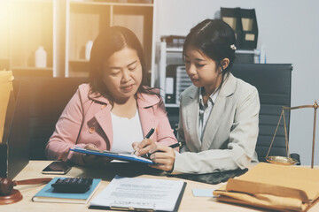 Obraz premium Consultation and conference of professional businesswoman and Male lawyers working and discussion having at law firm in office. Concepts of law, Judge gavel with scales of justice