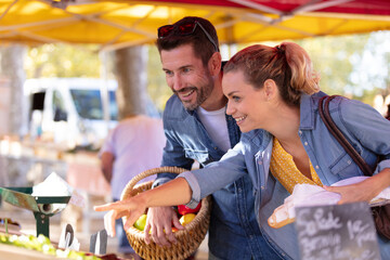 couple tourists looking at products on local market