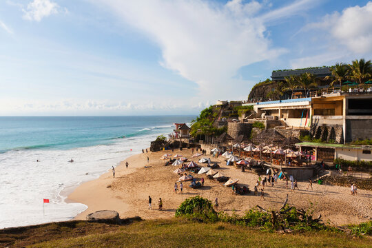 Dreamland Beach on Bukit Peninsula Bali with umbrellas and waves