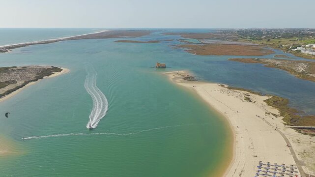 Aerial view of Fuseta beach sandbar in Algarve Portugal drone footage