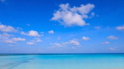 Obraz premium The summer vacation background with white sand Nature on the beach and sea ocean blue water in summer