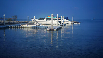 Yachts on the marina. Boat parked in the docks. Yachts in the port. 