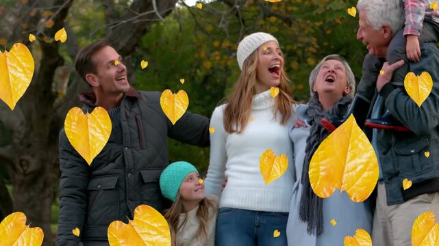 Animation of fall leaves falling over happy multigeneration caucasian family in autumn park