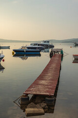 Wooden dock boats on sunset time