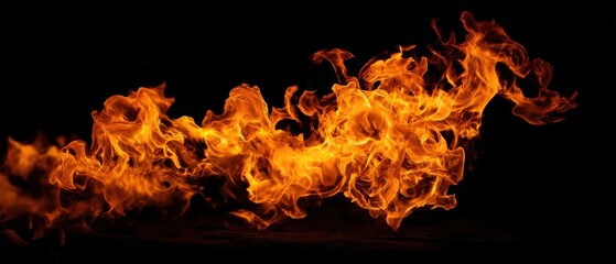 The Flames Dancing Across a Black Background Creating Intense Orange and Yellow Motion