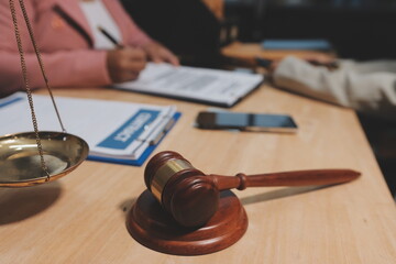 Consultation and conference of professional businesswoman and Male lawyers working and discussion having at law firm in office. Concepts of law, Judge gavel with scales of justice