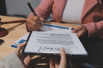 Consultation and conference of professional businesswoman and Male lawyers working and discussion having at law firm in office. Concepts of law, Judge gavel with scales of justice