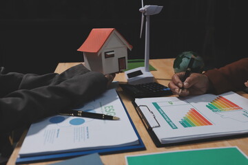 Asian woman lead young group of multiethnic businesspeople in team meeting, using laptop computer for ESG topic presentation on monitor. Sustainable business practice, people work at home concept