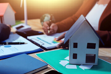 Asian woman lead young group of multiethnic businesspeople in team meeting, using laptop computer for ESG topic presentation on monitor. Sustainable business practice, people work at home concept