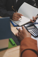 Asian woman lead young group of multiethnic businesspeople in team meeting, using laptop computer for ESG topic presentation on monitor. Sustainable business practice, people work at home concept