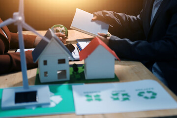 Asian woman lead young group of multiethnic businesspeople in team meeting, using laptop computer for ESG topic presentation on monitor. Sustainable business practice, people work at home concept