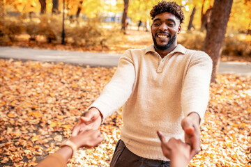 Couple Spinning Hand in Hand in Autumn Park