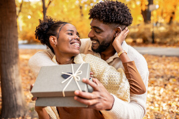 Couple Sharing a Sweet Surprise in Autumn Park