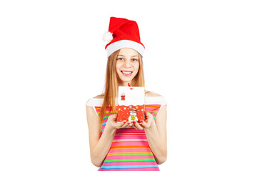 Happy young woman holding Christmas gift and smiling at camera