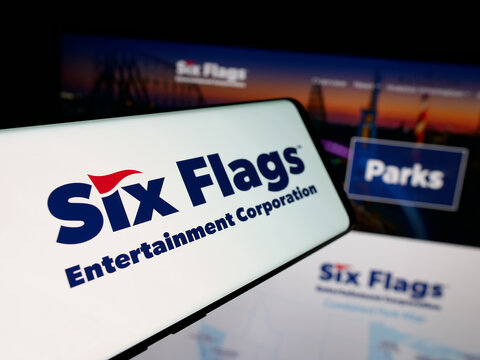 Stuttgart, Germany - 12-19-2025: Smartphone with logo of company Six Flags Entertainment Corporation on screen in front of website. Focus on center-left of phone display.