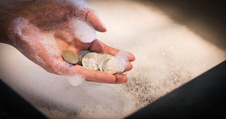 Hand Holding Coins Over Foamy Sink &mdash; Money Laundering Concept
