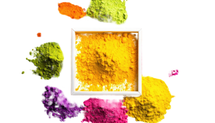 Vibrant colored powders surrounding a square white frame filled with yellow powder