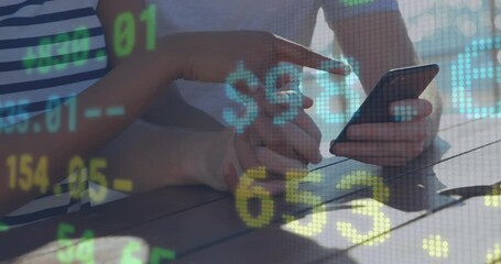 Animation of currency sign and numbers moving over diverse couple holding hands and using smartphone - Powered by Adobe