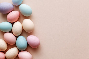 Colorful pastel Easter eggs on pastel beige background, soft spring holiday concept with copy space, colorful painted eggs, festive decoration Banner